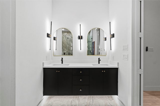 bathroom with vanity and a shower