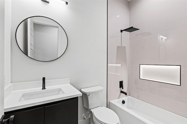 full bathroom featuring tiled shower / bath, vanity, and toilet