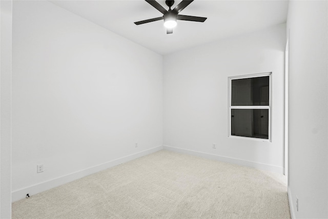 empty room featuring light colored carpet and ceiling fan