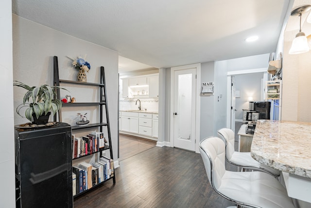 office area with sink and dark hardwood / wood-style floors