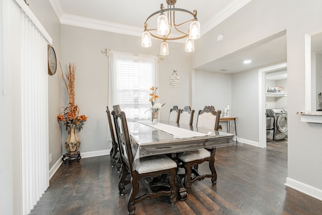 dining space with dark hardwood / wood-style flooring, crown molding, washer and dryer, and a chandelier