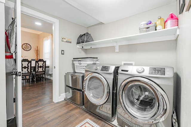 clothes washing area featuring separate washer and dryer and dark hardwood / wood-style flooring