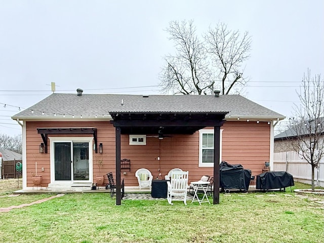 rear view of house featuring a lawn