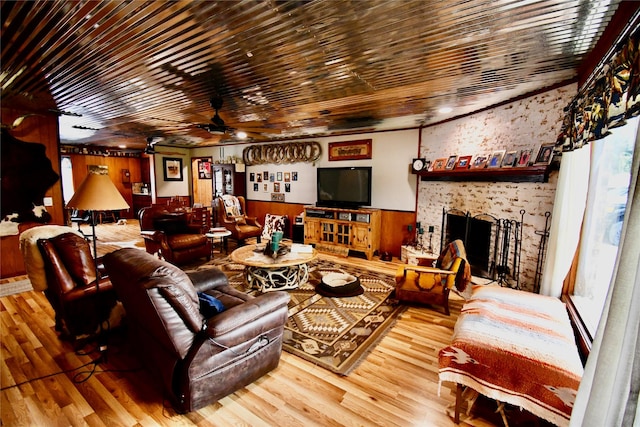 living room with ceiling fan, a fireplace, and hardwood / wood-style floors