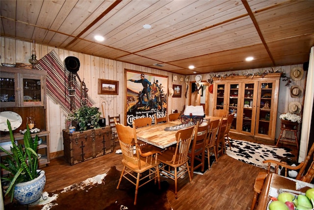 dining area with wood ceiling, wood walls, and hardwood / wood-style flooring