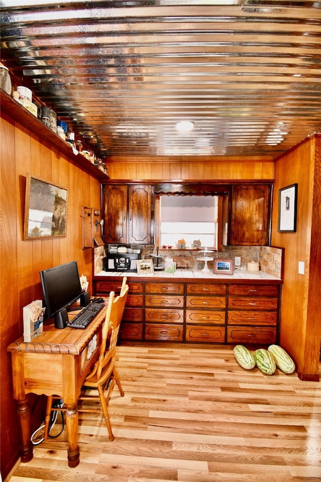 kitchen with wood ceiling, wooden walls, and light wood-type flooring