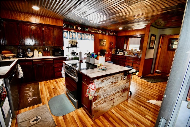 kitchen with black range with electric stovetop, backsplash, light hardwood / wood-style floors, and wooden ceiling