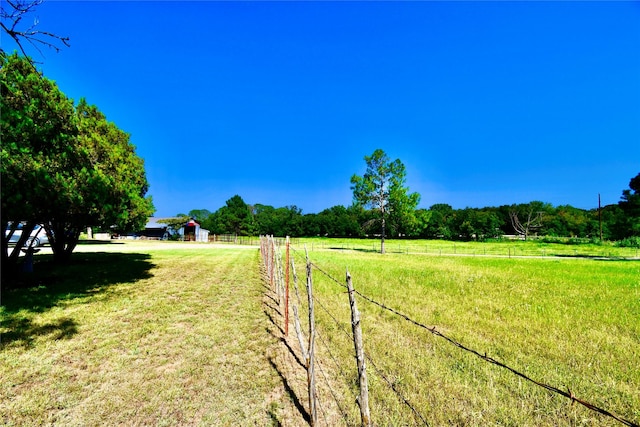 view of yard with a rural view