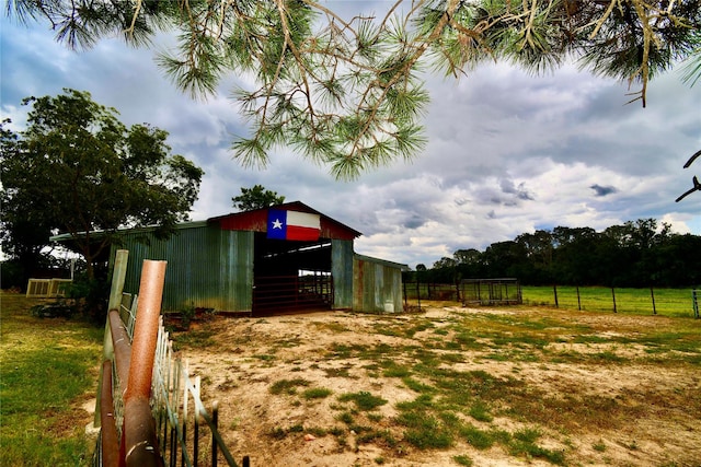 view of yard with an outdoor structure and a rural view