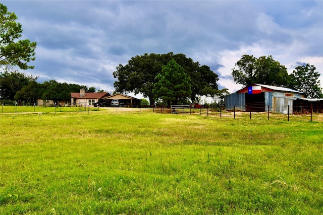 view of yard featuring an outbuilding and a rural view