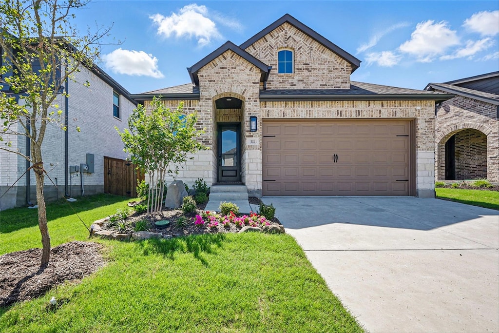 3824 Talisker Blvd, Sherman, TX 75090 - french provincial home with brick siding, driveway, a garage, and a front yard