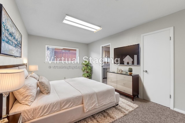 carpeted bedroom with connected bathroom