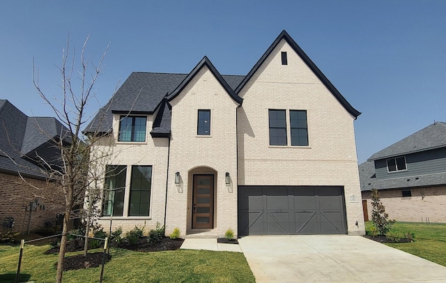 view of front of home with brick siding, driveway, a front lawn, and a garage