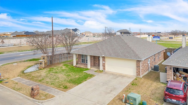 ranch-style house with a garage, central AC, and a front yard