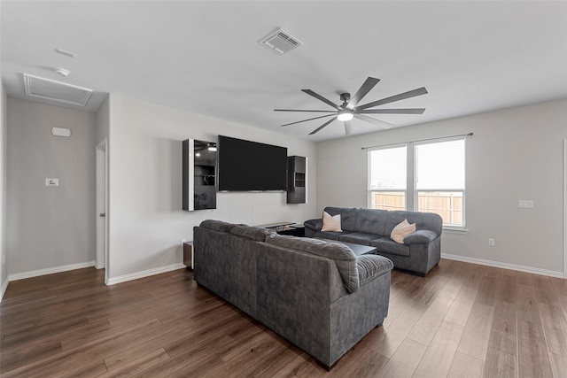 living room with dark wood-type flooring and ceiling fan