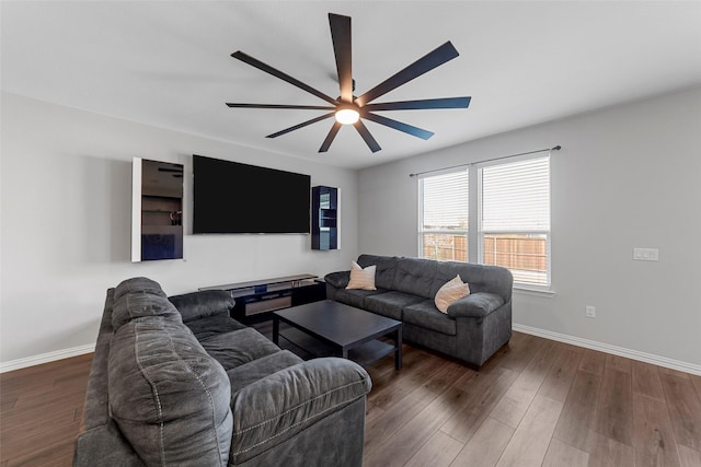 living room with ceiling fan and dark hardwood / wood-style flooring