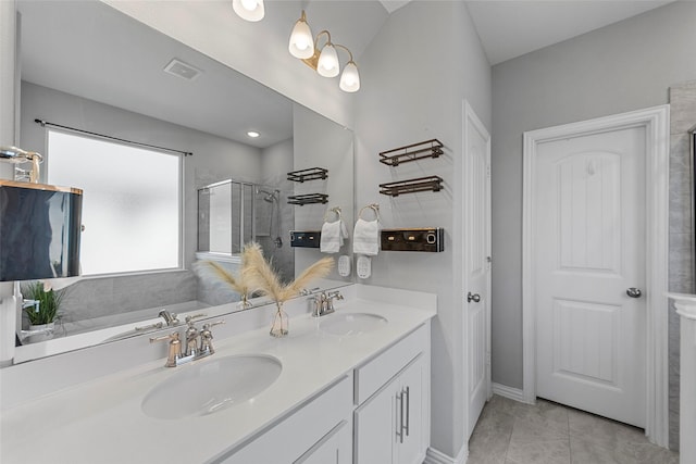 bathroom featuring shower with separate bathtub, tile patterned floors, and vanity