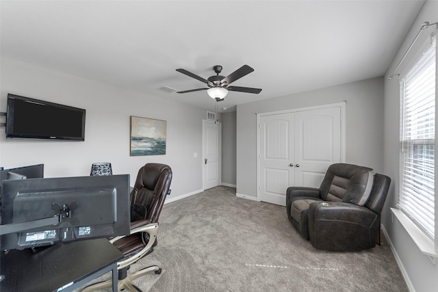 carpeted home office featuring ceiling fan