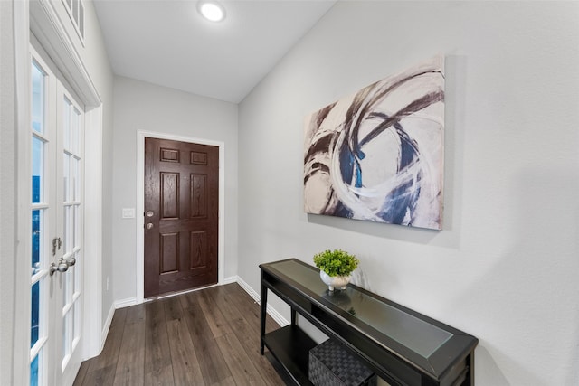 foyer entrance featuring visible vents, baseboards, and dark wood-style flooring