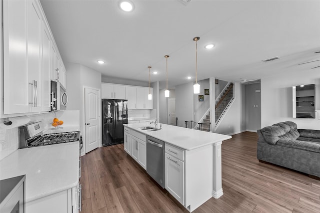 kitchen with white cabinetry, an island with sink, and appliances with stainless steel finishes