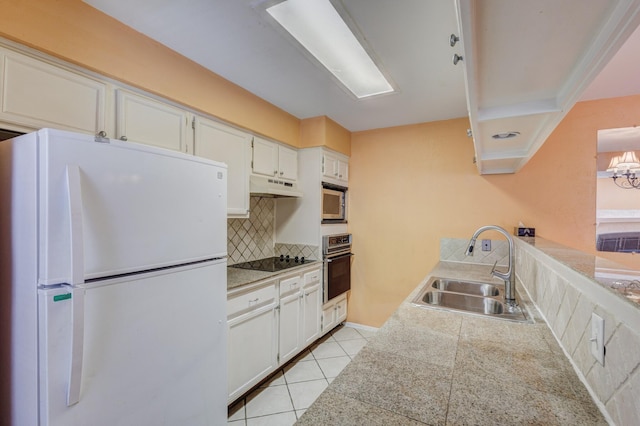 kitchen with tile countertops, stainless steel appliances, white cabinets, a sink, and under cabinet range hood