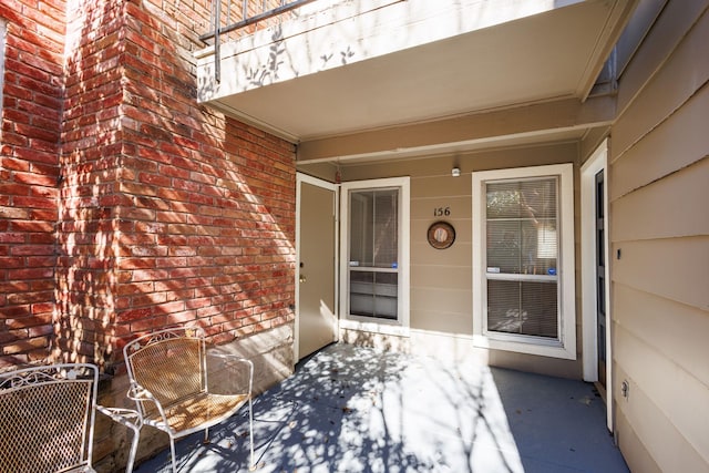 property entrance featuring brick siding