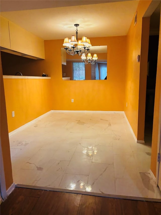 unfurnished dining area featuring a chandelier