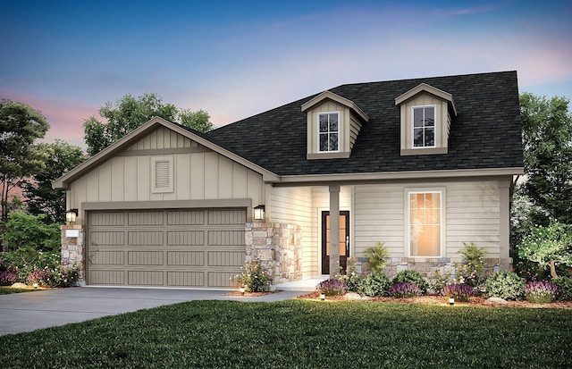 view of front of property with a garage and a lawn