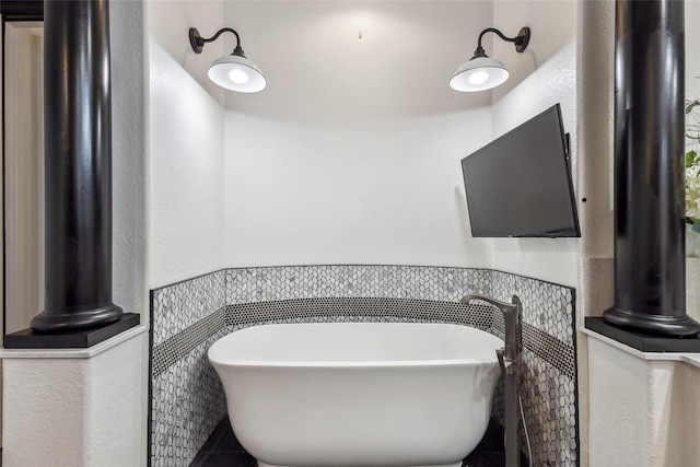 bathroom with tile walls, tile patterned floors, and a bathing tub