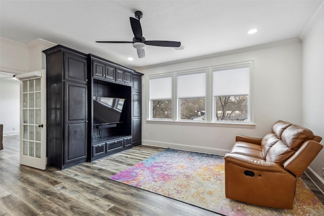 living room with crown molding, ceiling fan, and dark hardwood / wood-style floors