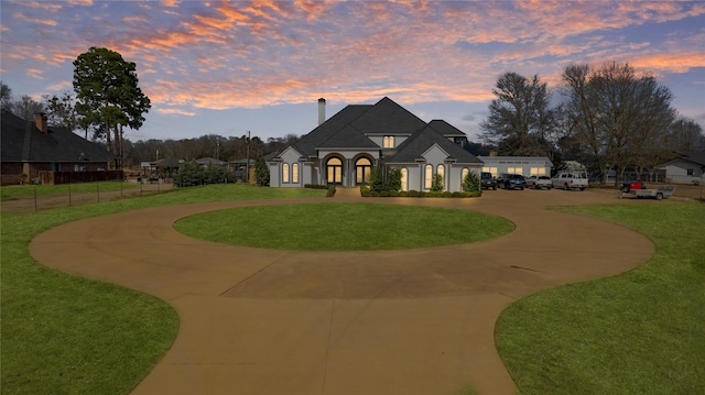 french provincial home featuring a lawn