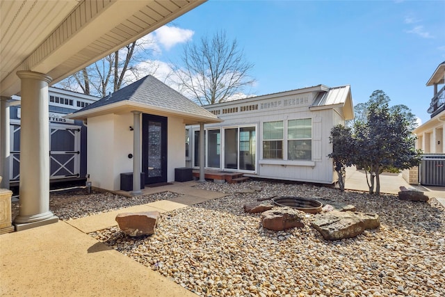 back of house featuring central AC unit