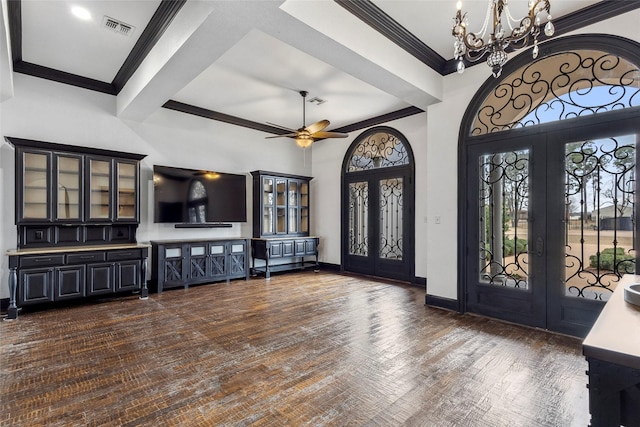 foyer featuring crown molding, dark hardwood / wood-style floors, ceiling fan with notable chandelier, and french doors