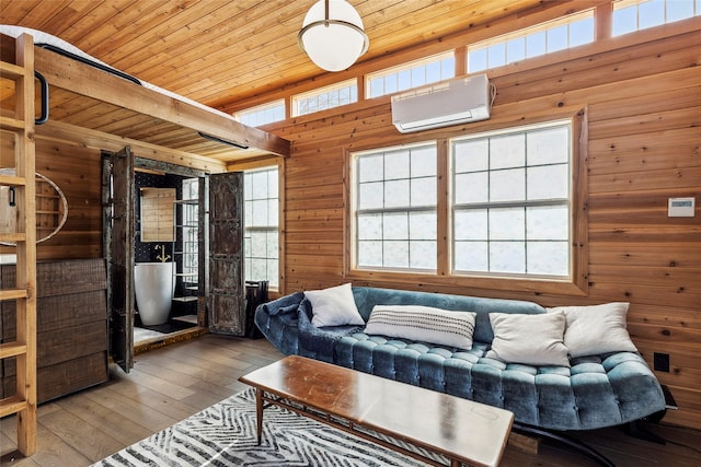 living room featuring hardwood / wood-style floors, a wall mounted air conditioner, wood walls, beamed ceiling, and wooden ceiling