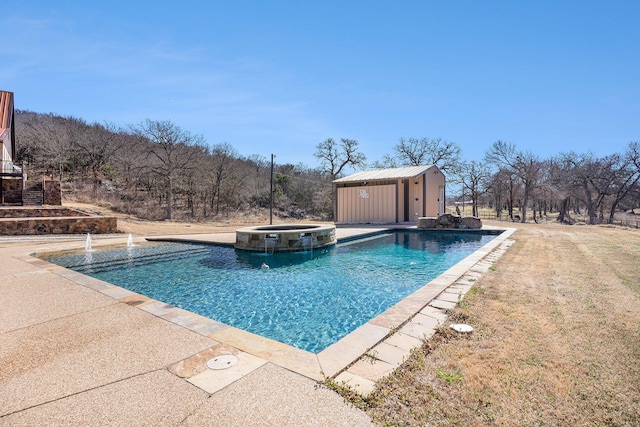 view of swimming pool featuring an outbuilding, a patio, and a pool with connected hot tub