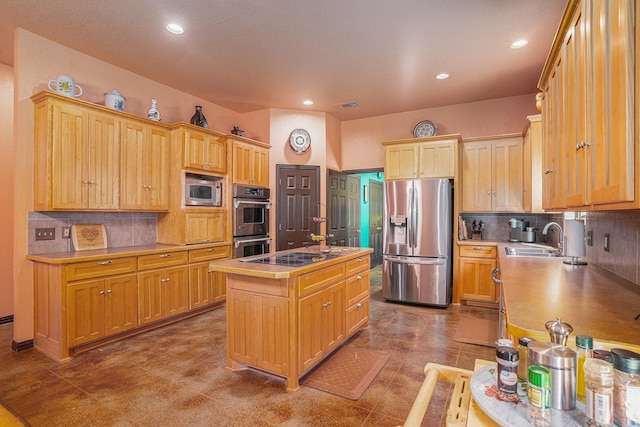 kitchen featuring an island with sink, tasteful backsplash, appliances with stainless steel finishes, and light countertops