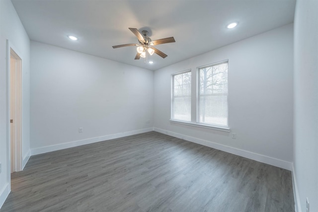 spare room featuring ceiling fan and dark hardwood / wood-style flooring