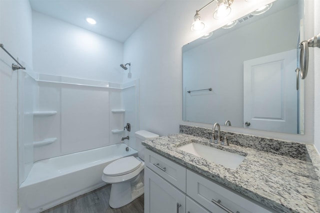 full bathroom with shower / bathing tub combination, vanity, hardwood / wood-style floors, and toilet