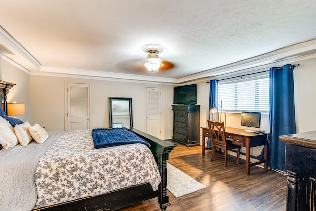 bedroom featuring dark wood-type flooring, ceiling fan, crown molding, and a textured ceiling