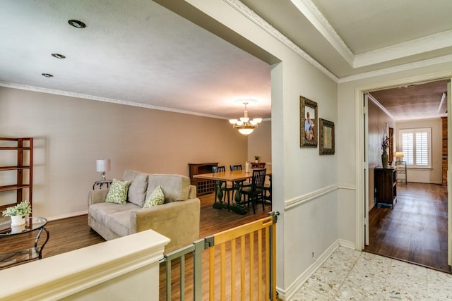 living room with an inviting chandelier, crown molding, baseboards, and tile patterned floors