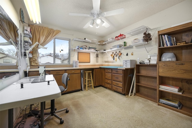 office area featuring ceiling fan, light colored carpet, and a textured ceiling