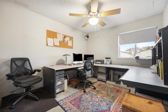 office space featuring ceiling fan and a textured ceiling