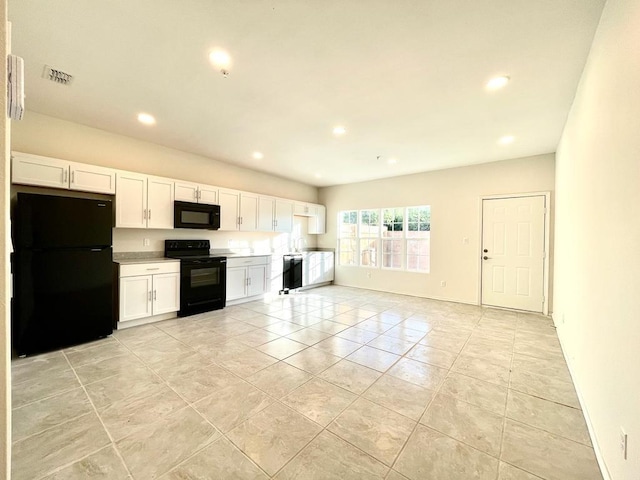 kitchen with black appliances, white cabinets, and light tile patterned flooring