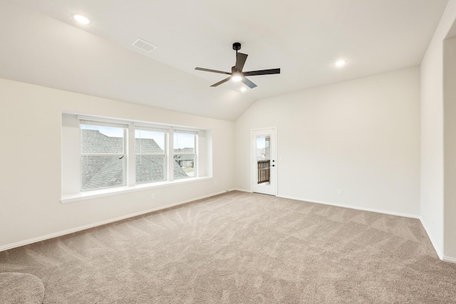 carpeted empty room featuring ceiling fan and lofted ceiling