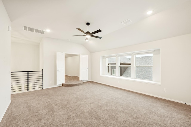 carpeted empty room featuring ceiling fan and lofted ceiling