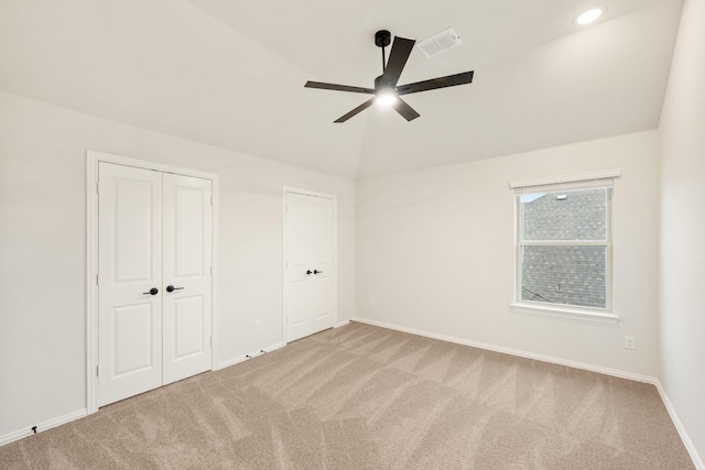 unfurnished bedroom with vaulted ceiling, ceiling fan, and carpet flooring