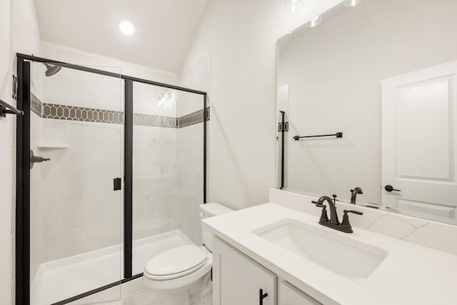 bathroom featuring vanity, a shower with shower door, lofted ceiling, and toilet