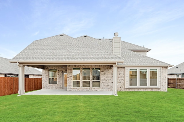 back of property with a patio and a lawn