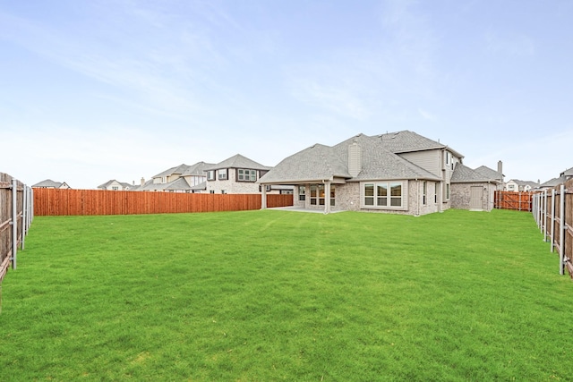 rear view of house with a yard