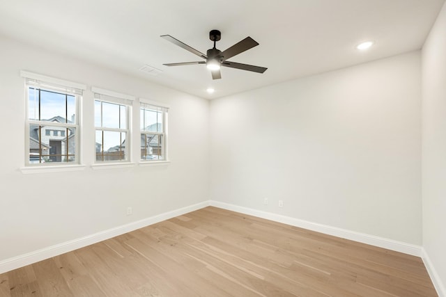 spare room featuring ceiling fan and light hardwood / wood-style flooring